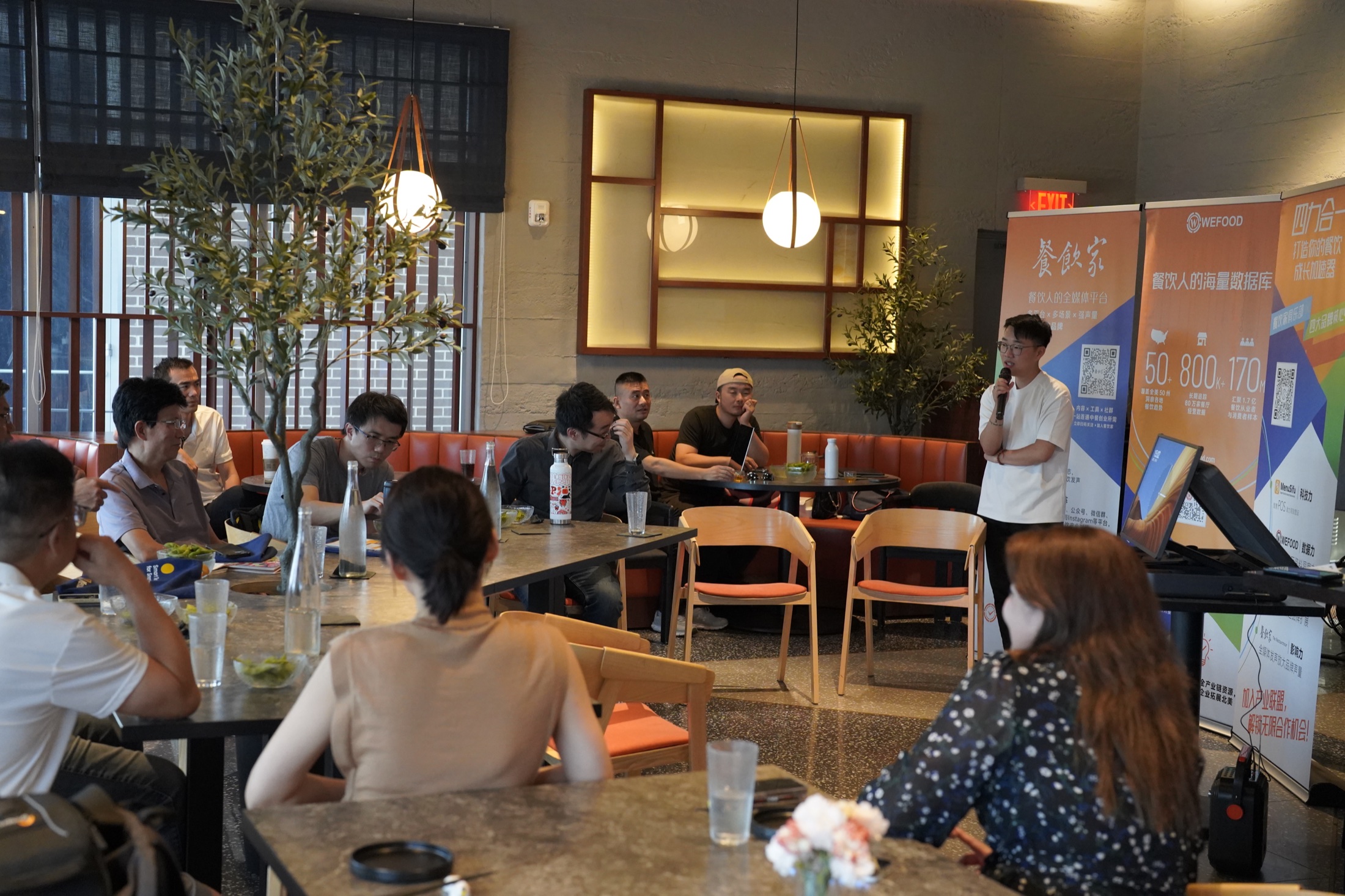 Restaurant owners listening to a speaker at a WeFood gathering in Houston